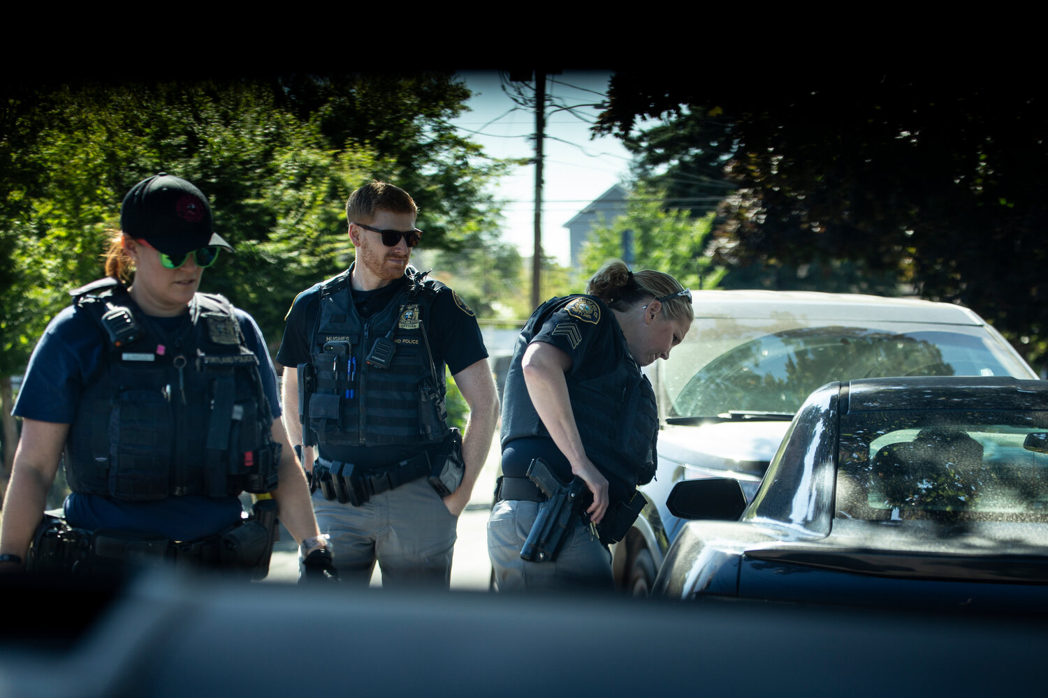 Members of the Portland Police Bureau’s Human Trafficking Unit interrupt a “car date” during a directed patrol mission in Northeast Portland in July. (Moriah Ratner/InvestigateWest)